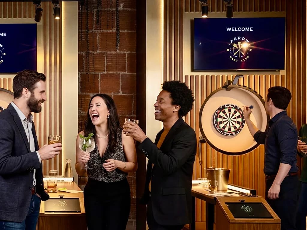 Team members laughing together at Arrow Dart Club Kansas City corporate event