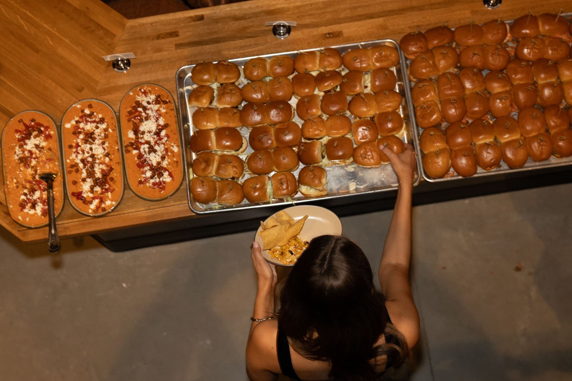 Overhead view of a catering spread with sliders and dips at a private event