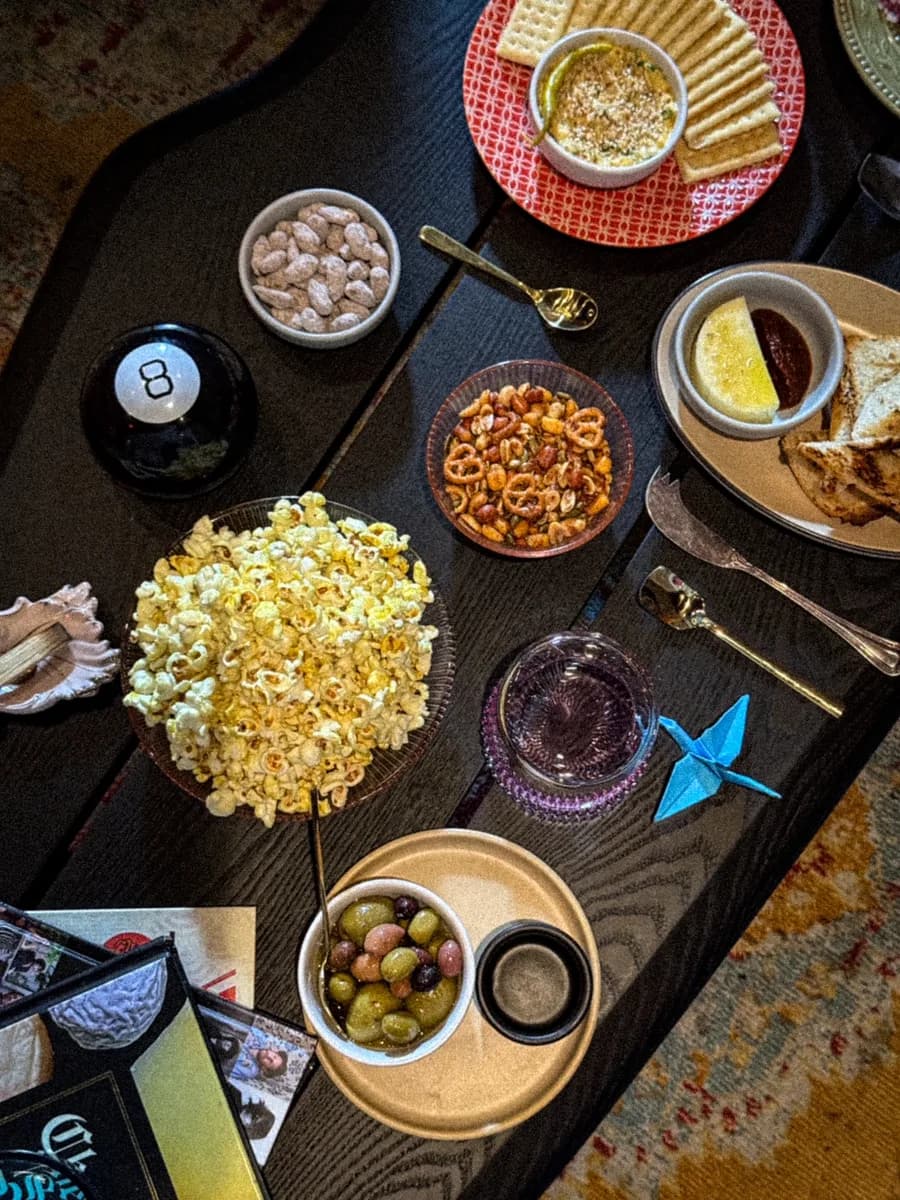 Sunken Cork snack spread — popcorn, olives, and wine bar bites