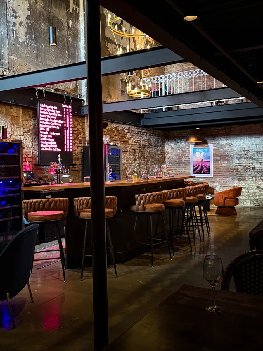 Sunken Cork bar interior with exposed brick and neon wine list