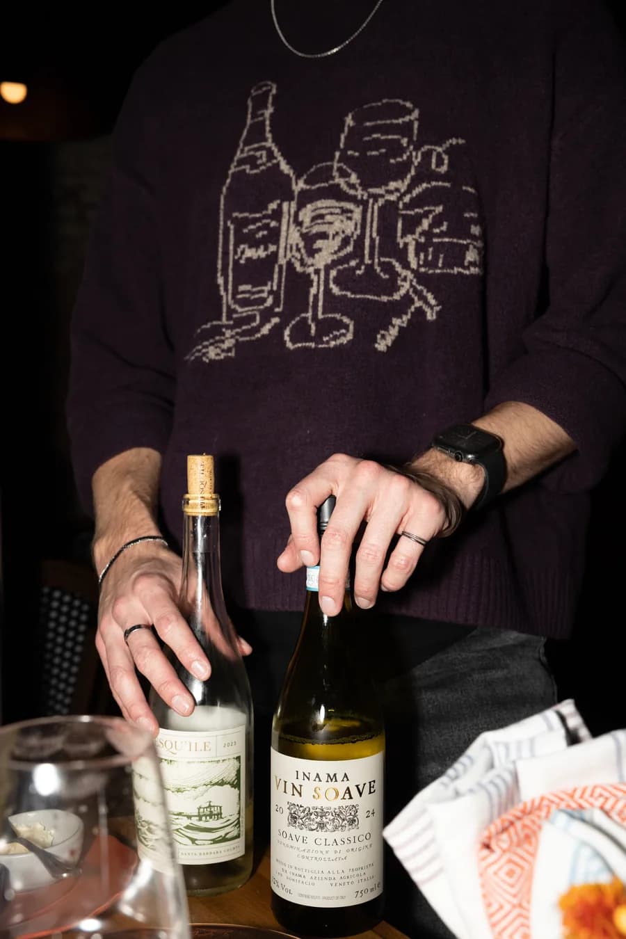 Sommelier presenting wine bottles at Sunken Cork